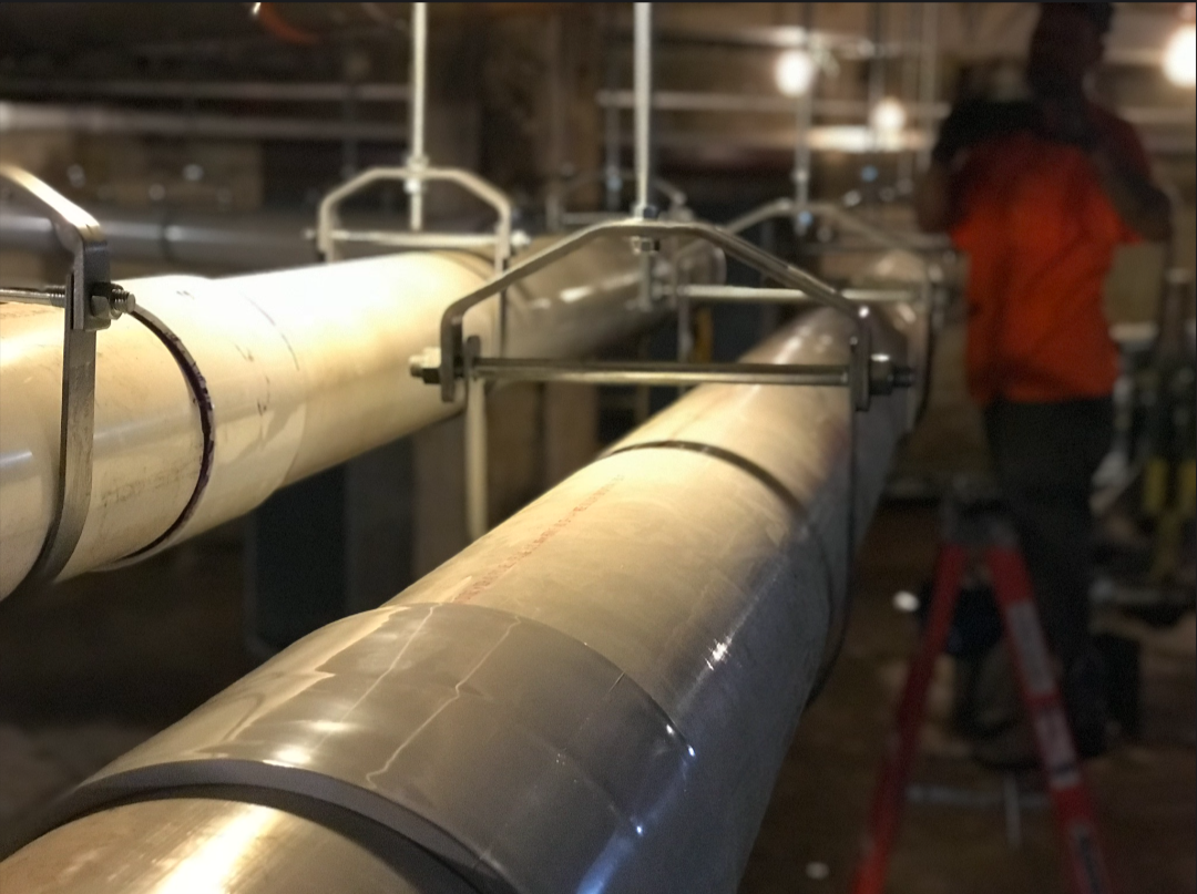 Large-diameter pipe installation in a commercial space