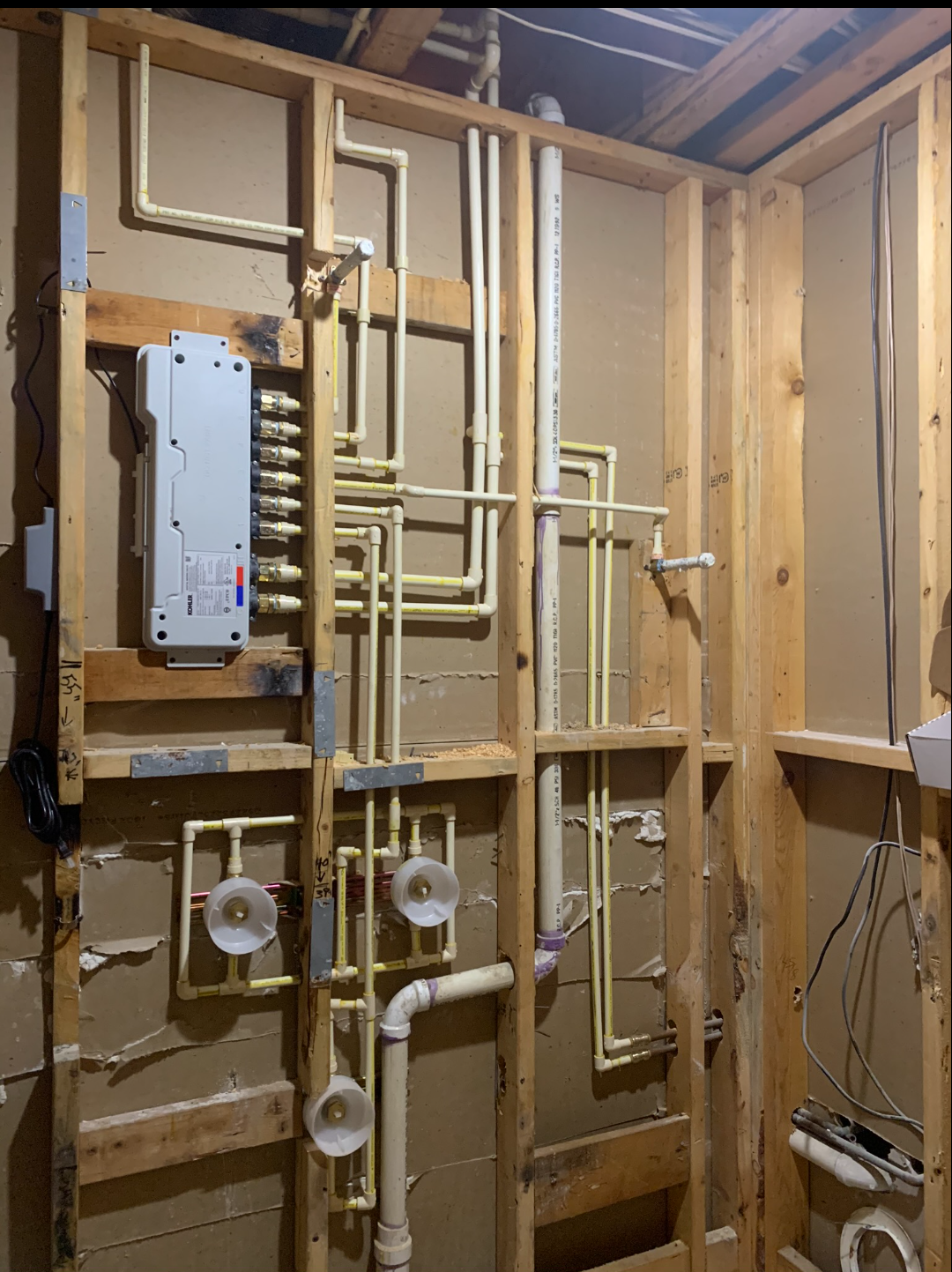In-wall plumbing manifold and bathroom rough-in installation