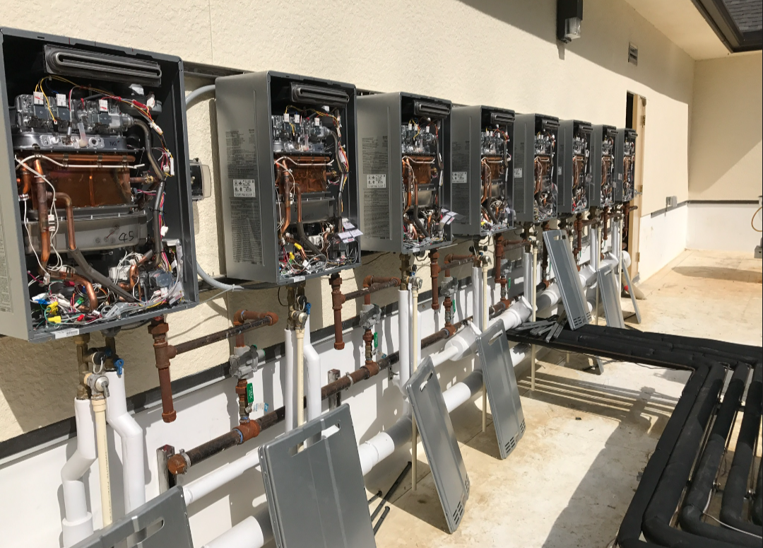 Bank of tankless water heaters servicing a commercial building