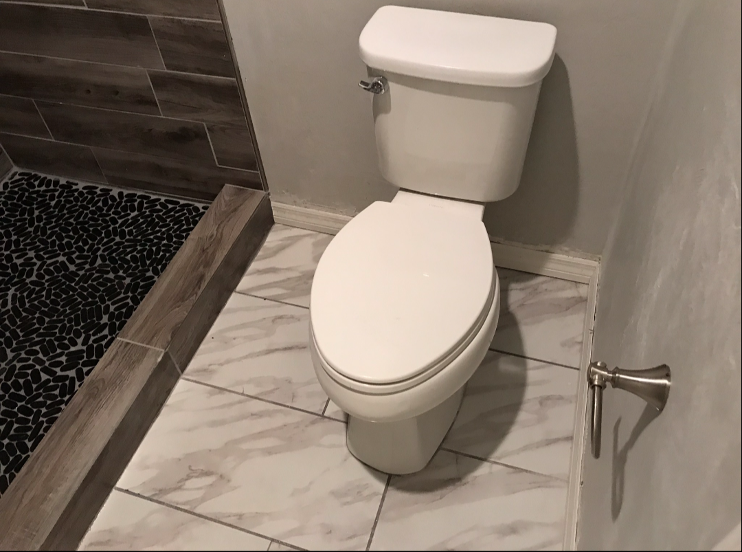 New toilet installed on tile floor